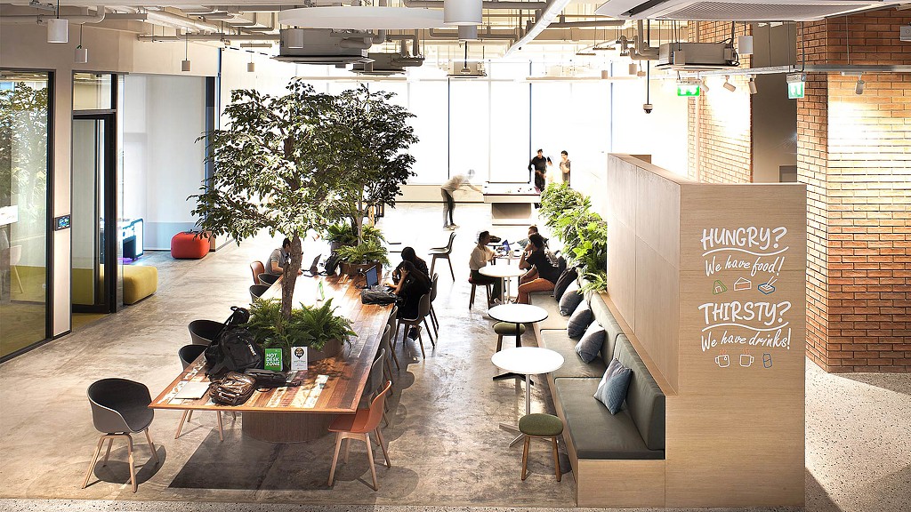 A group of people sitting at tables in a building.